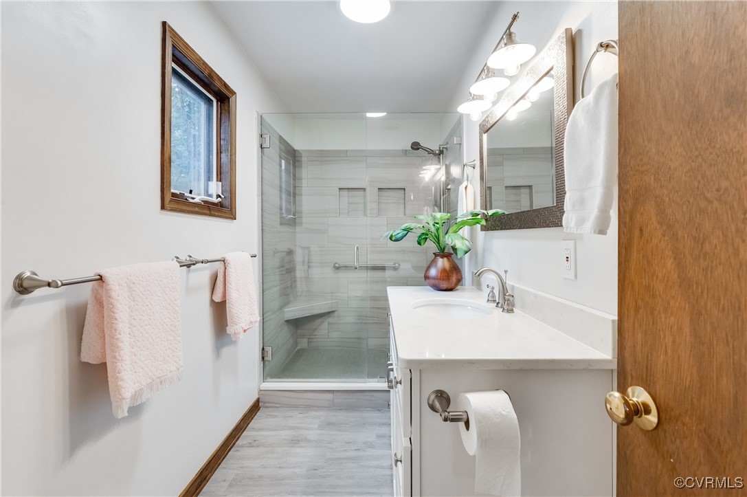 13321 Hensley Road Chesterfield, VA 23832 - Photo 24 of 48 a bathroom with a sink a mirror and a shower