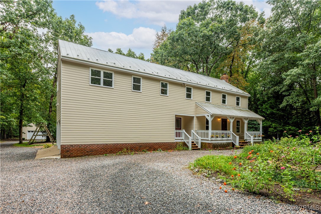 13321 Hensley Road Chesterfield, VA 23832 - Photo 41 of 48 a view of a white house with large windows and a small yard