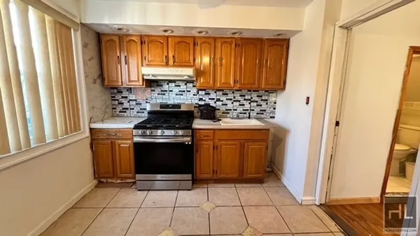 a kitchen with a stove a sink and a refrigerator