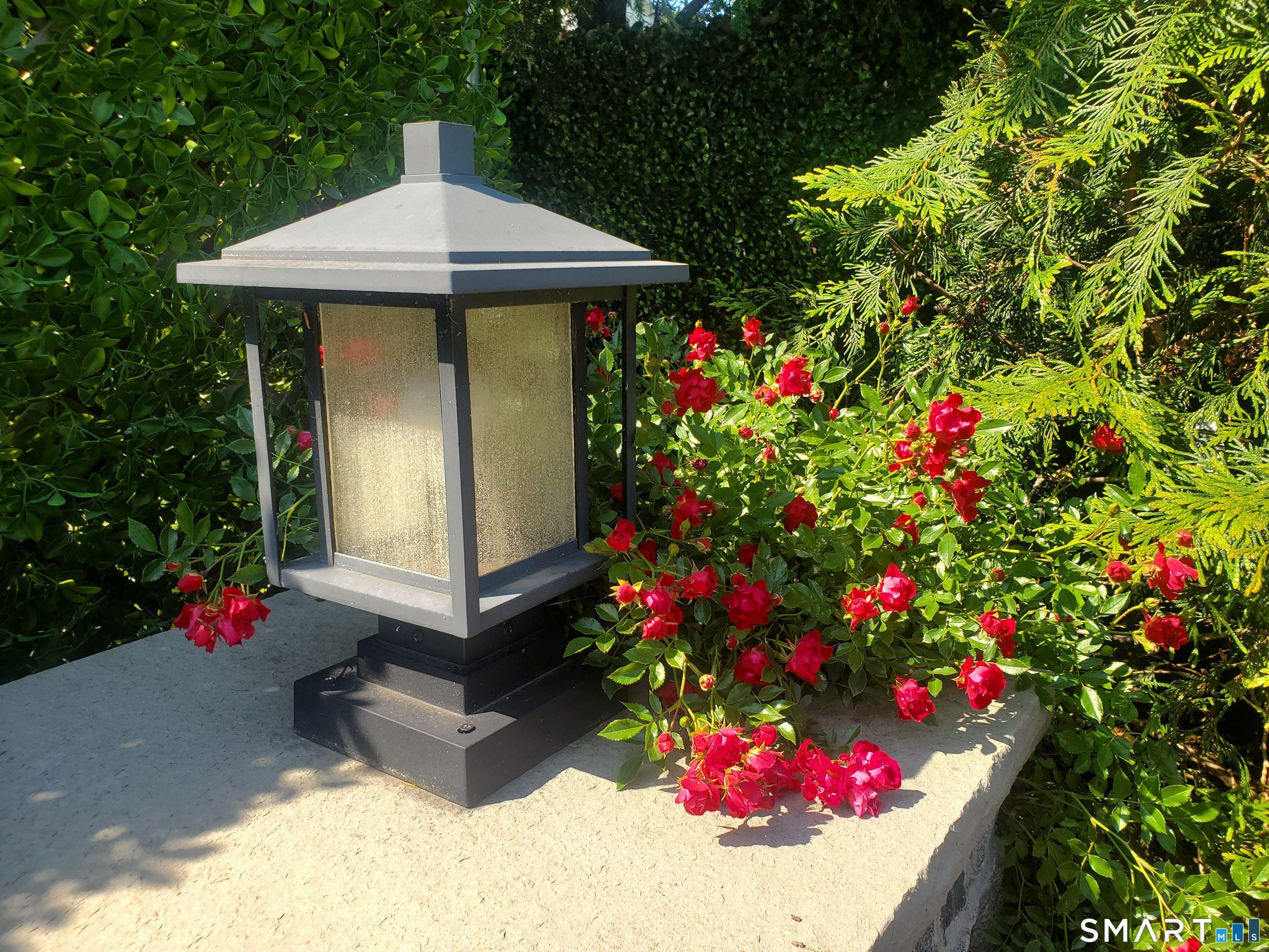 a front view of a house with a yard and fountain