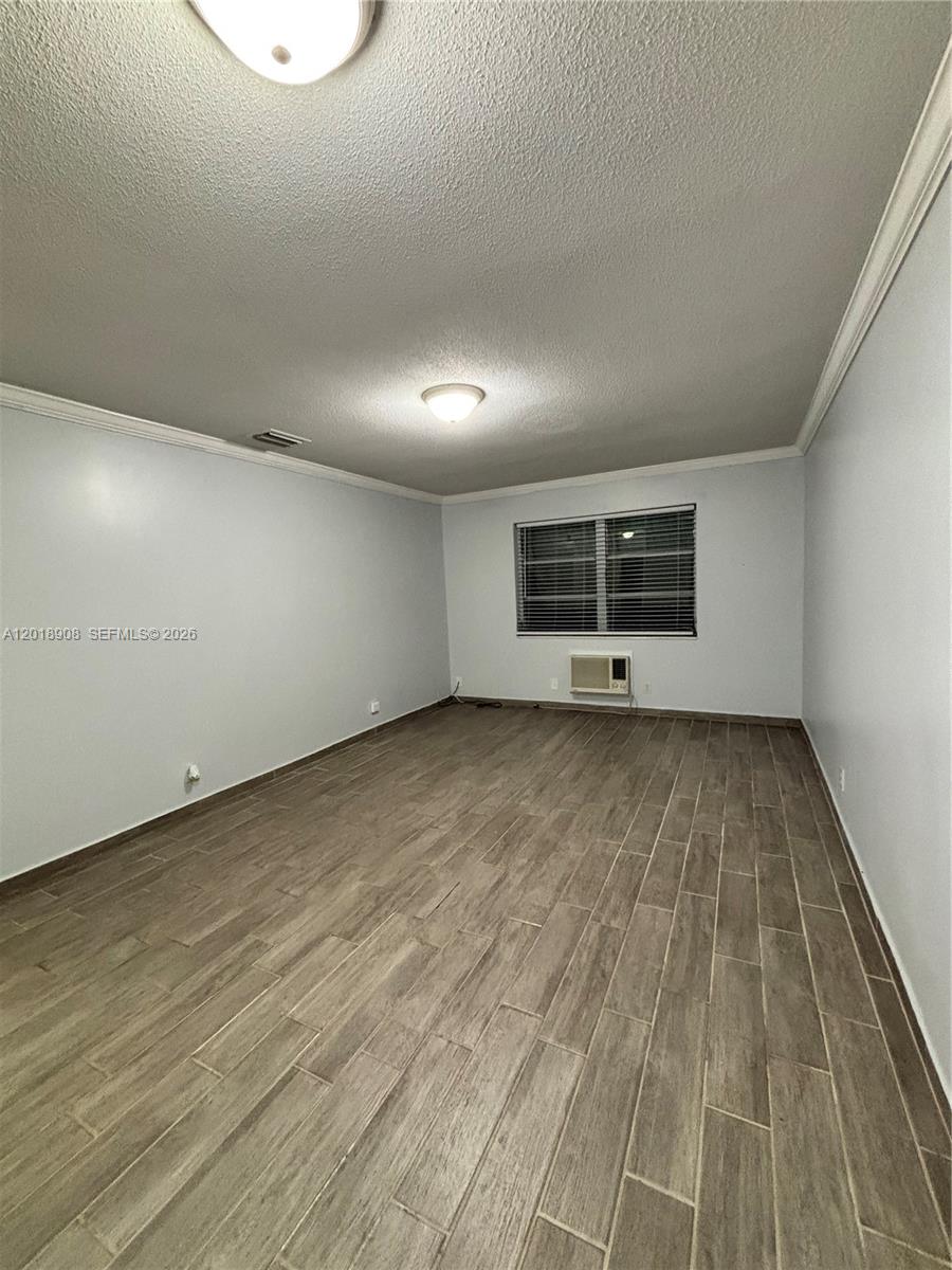 1480 East Sample Road, Unit 209 Pompano Beach, FL 33064 - Photo 9 of 24 an empty room with wooden floor and windows