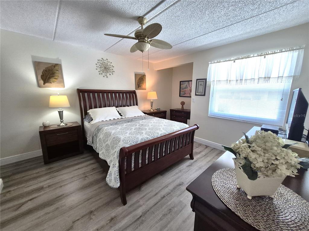 107 Windward Place, Unit 107 Oldsmar, FL 34677 - Photo 19 of 34 a bedroom with a bed and a dresser