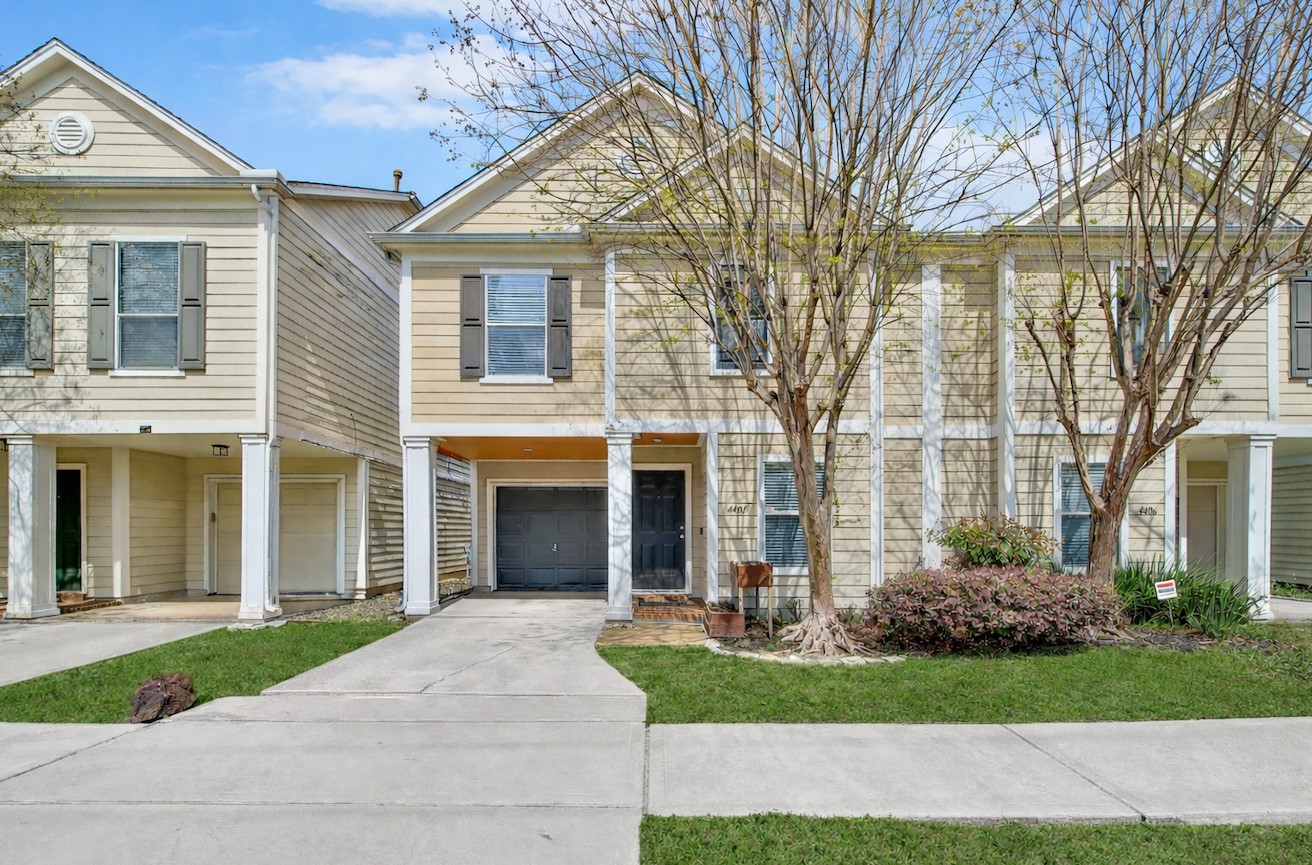 Charming two-story townhome with great curb appeal, private garage, and welcoming covered entry in the heart of Rice Military