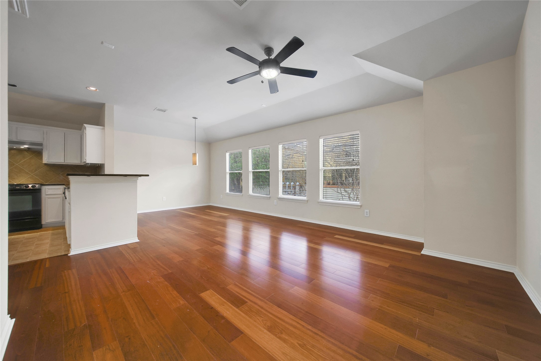 4408 Eigel Street Houston, TX 77007 - Photo 7 of 16 Beautiful Brazilian cherry hardwood floors highlight this spacious living room, which flows naturally into the dining area and kitchen for an easy open-concept layout.