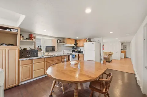 a dining room with kitchen island a table and chairs