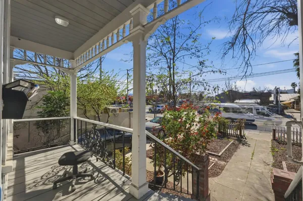 a balcony with furniture and flowers