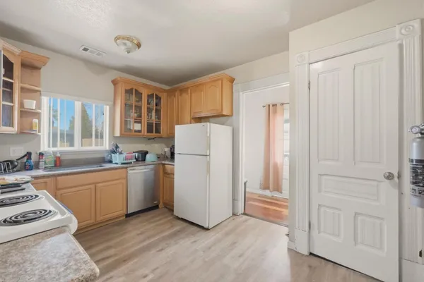 a kitchen with stainless steel appliances granite countertop a refrigerator and a stove top oven
