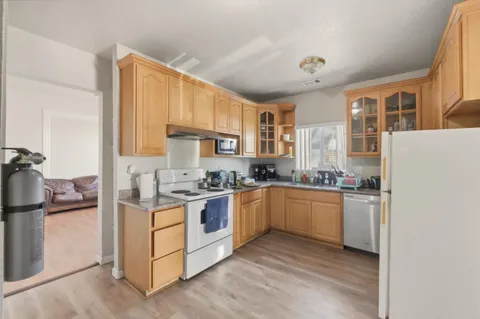 a kitchen with a stove top oven sink and cabinets