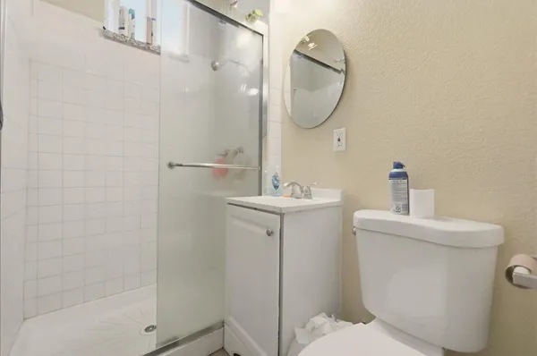 a bathroom with a sink a toilet and shower