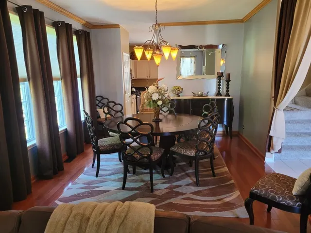 a view of a dining room with furniture and window