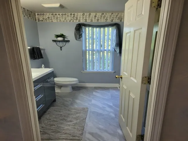 a bathroom with a toilet and a shower