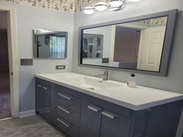 a bathroom with a sink and a mirror