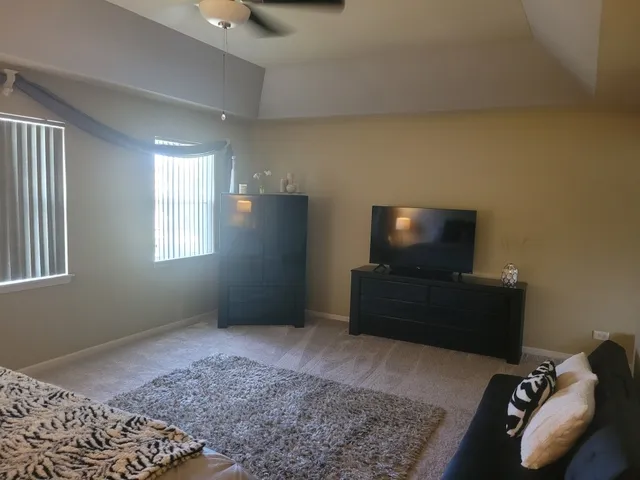 a bedroom with a bed and flat screen tv