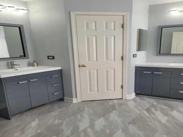 a spacious bathroom with a double vanity sink and a mirror