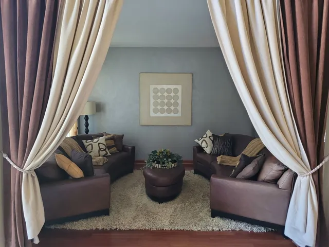 a living room with furniture and a potted plant