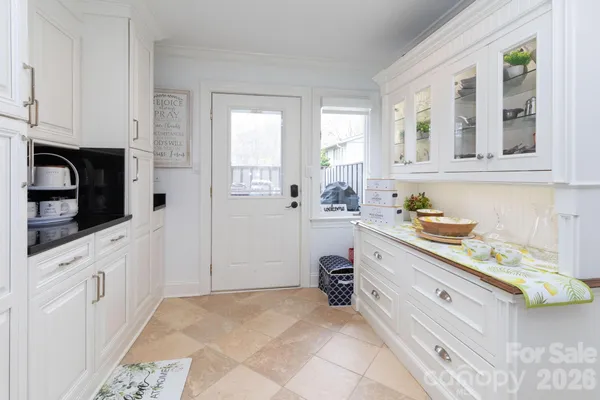 a spacious bathroom with a granite countertop sink and a bathtub