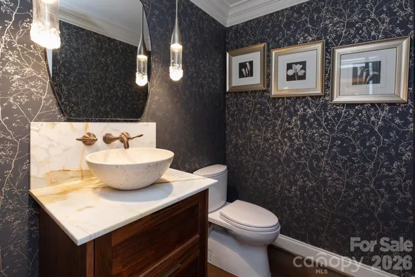 a bathroom with a sink toilet and mirror