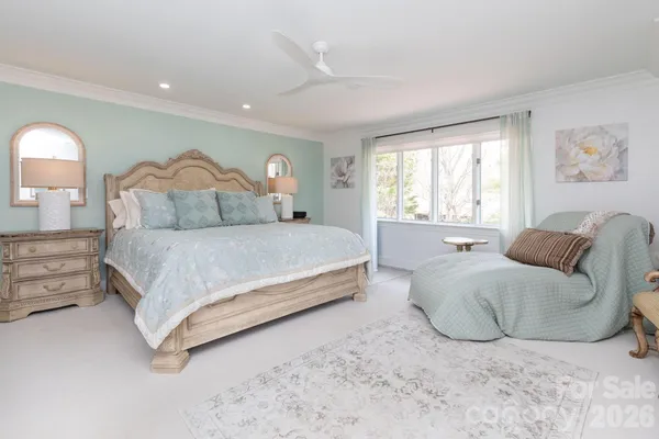 a spacious bedroom with a bed and a couch