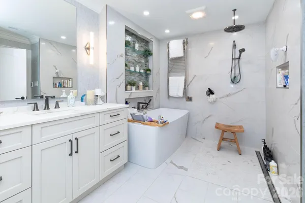 a bathroom with a double vanity sink mirror and toilet