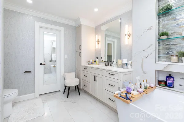 a bathroom with a sink mirror vanity and toilet