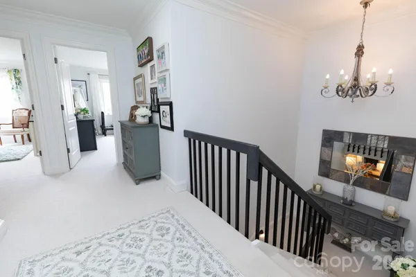 a view of a livingroom with furniture and staircase