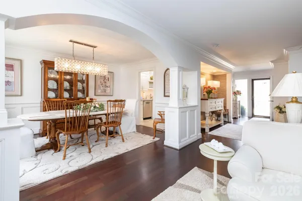 a living room with furniture a dining table and a fireplace