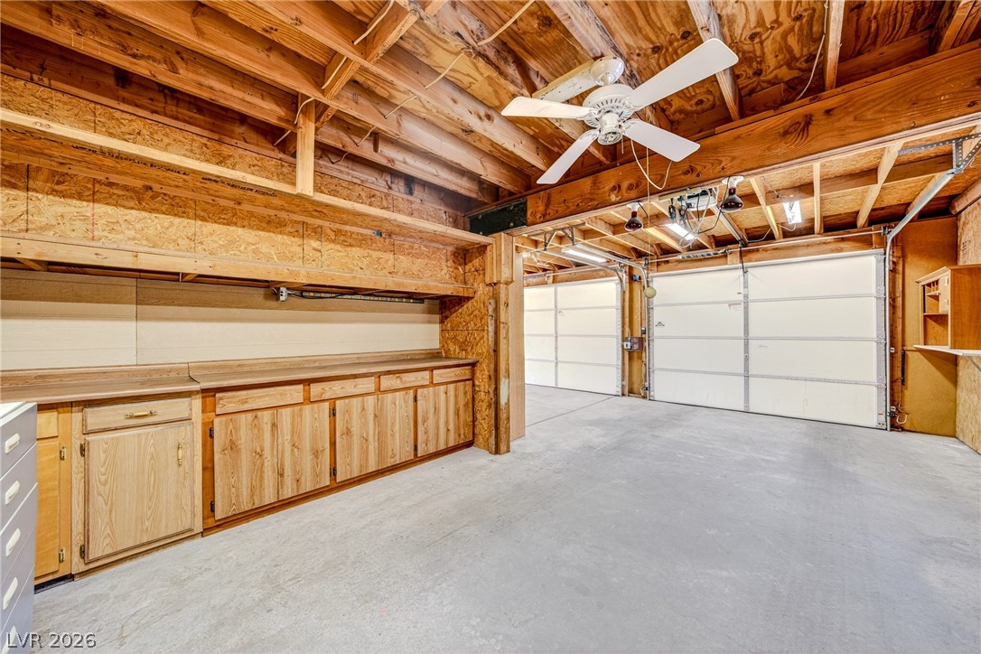 1831 West Horn Road Pahrump, NV 89048 - Photo 22 of 59 A spacious garage with built-in cabinetry provides ample storage and workspace.