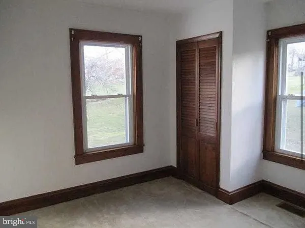 a view of an empty room and wooden floor