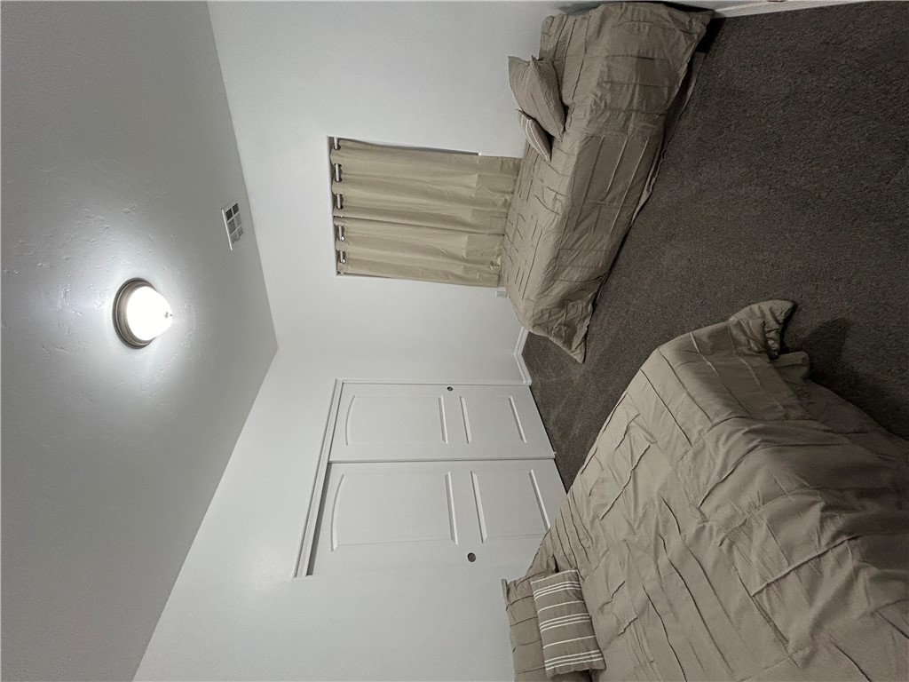 2191 Seneca Street Kingman, AZ 86401 - Photo 23 of 26 a bedroom with a bed and a night stand