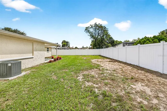 a view of a house with a backyard