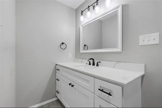 a bathroom with a sink and a mirror