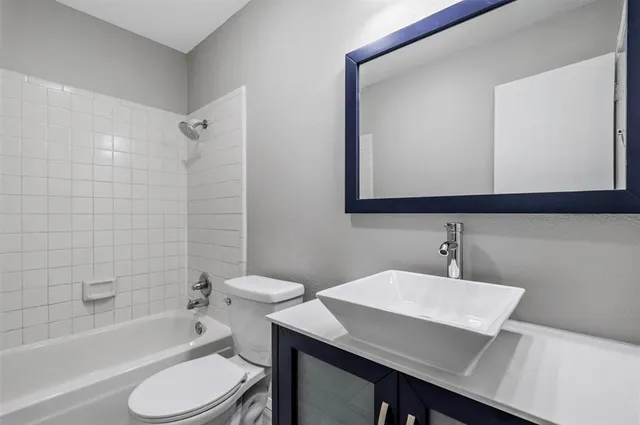 a bathroom with a sink a toilet and bathtub