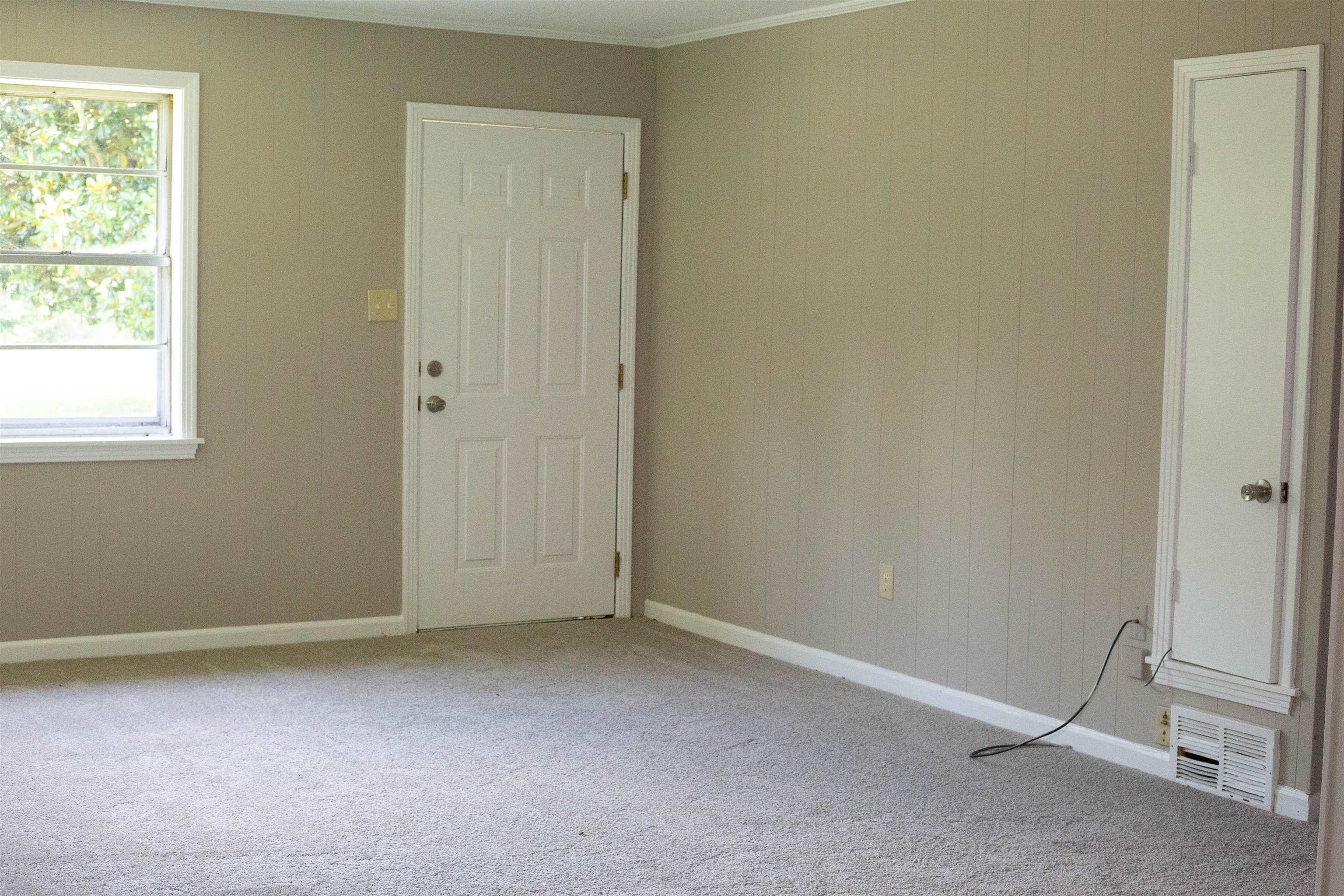 583 Armstrong Road Drummonds, TN 38023 - Photo 8 of 14 Neutral-toned paneled walls with white trim and light gray carpeting
