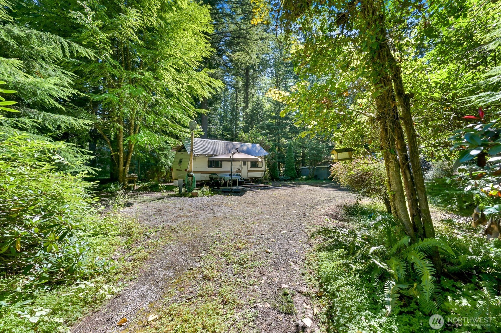 3013 Tower Road Maple Falls, WA 98266 - Photo 14 of 38 a car parked in front of a house with large trees