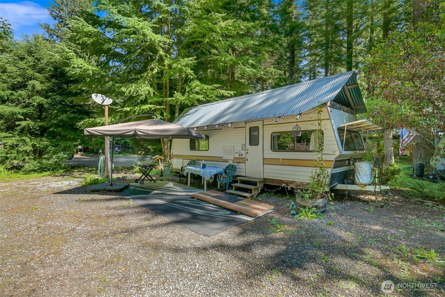 3013 Tower Road Maple Falls, WA 98266 - Photo 16 of 38 a backyard of a house with table and chairs under an umbrella