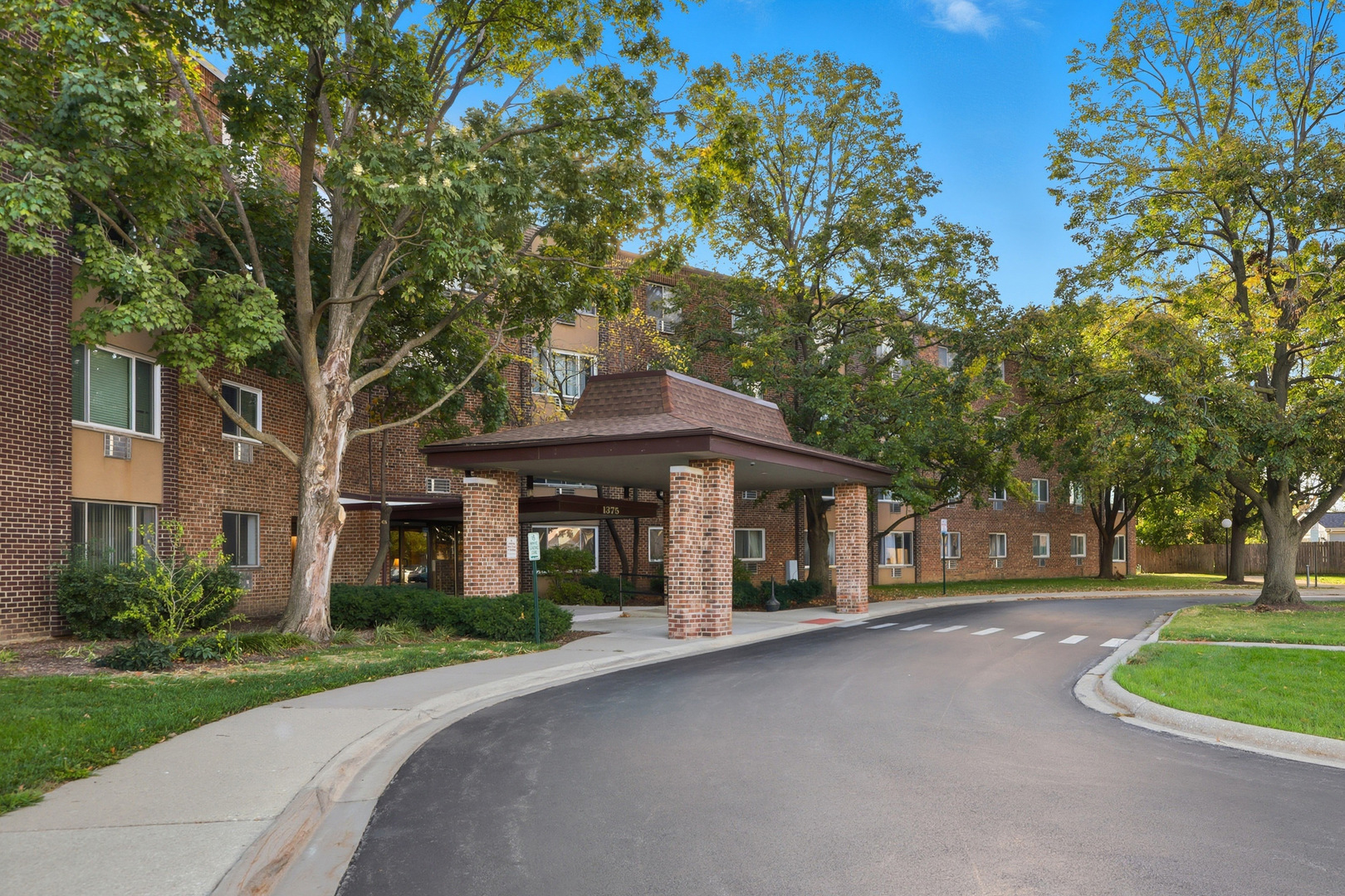 1375 Rebecca Drive, Unit 213 Hoffman Estates, IL 60169 - Photo 1 of 21 a front view of a house with garden