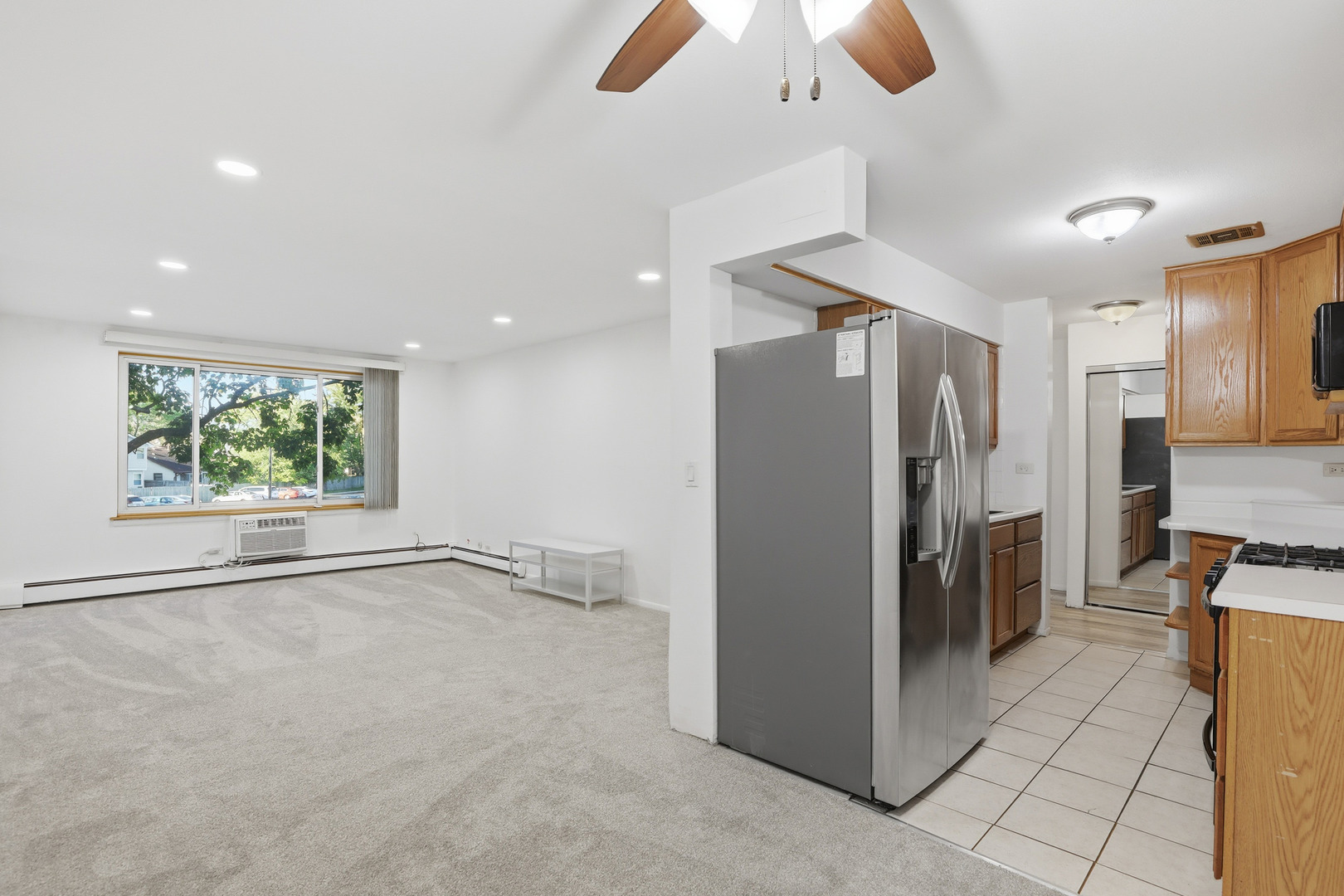 1375 Rebecca Drive, Unit 213 Hoffman Estates, IL 60169 - Photo 8 of 21 a view of a refrigerator in kitchen and a window