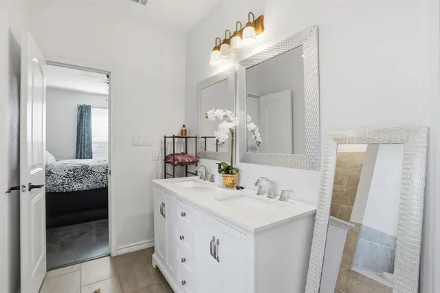 a bathroom with a sink vanity granite and a mirror