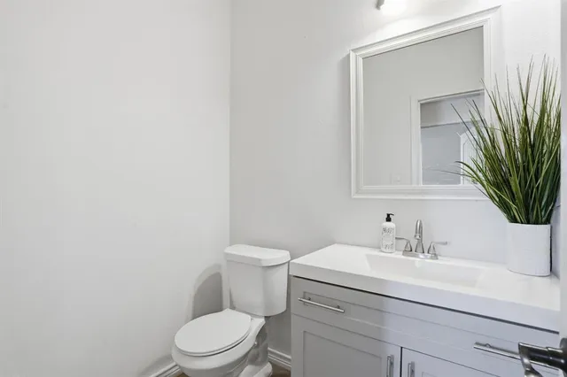 a bathroom with a sink a toilet and mirror
