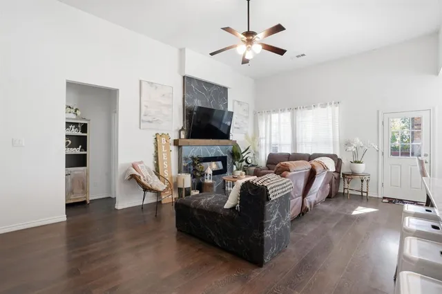 a living room with furniture fireplace and a flat screen tv