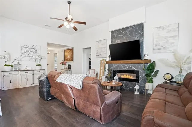 a living room with furniture fireplace and a flat screen tv