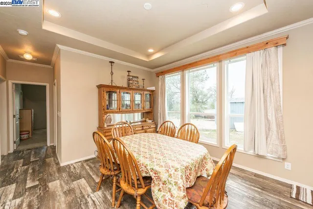 a large kitchen with kitchen island granite countertop a large counter top and stainless steel appliances