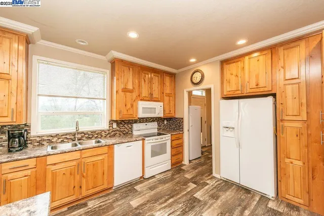 a view of a kitchen center island wooden floor and furniture