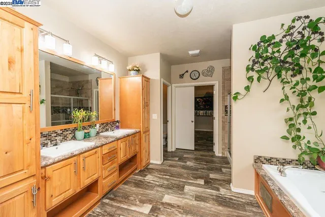 a bathroom with a glass shower door and a window