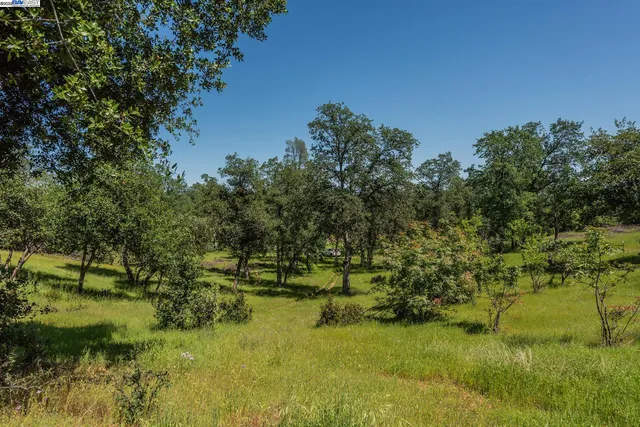 a view of a swimming pool with an outdoor seating and a yard