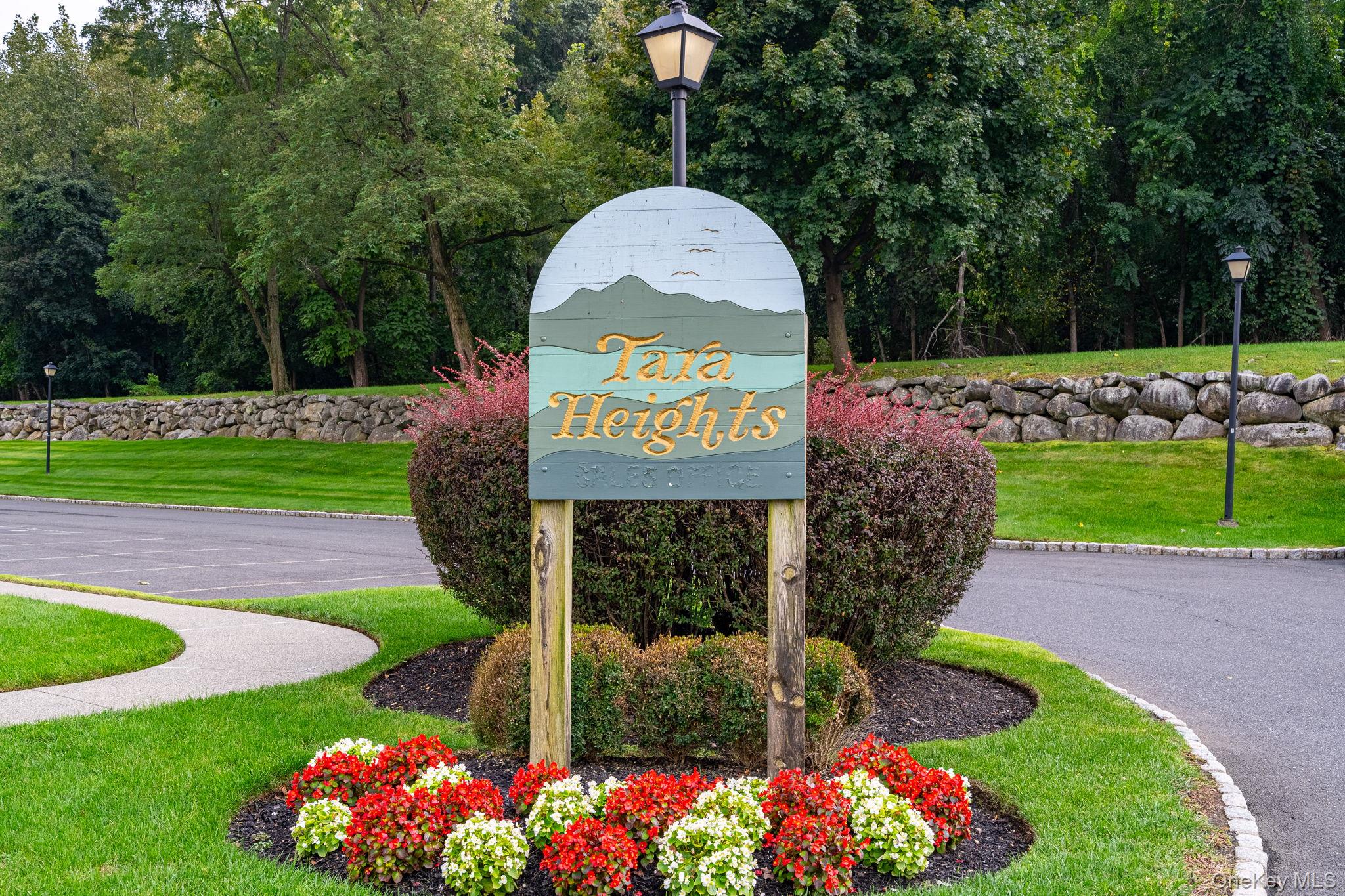 a sign that is sitting in front of flowers