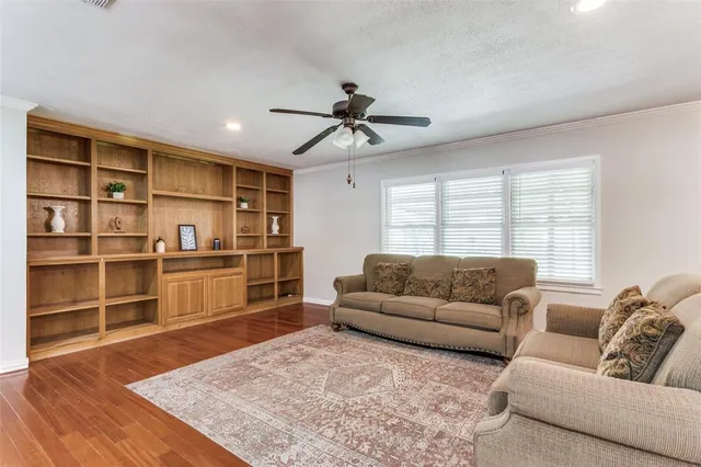 a living room with a couch and a book shelf