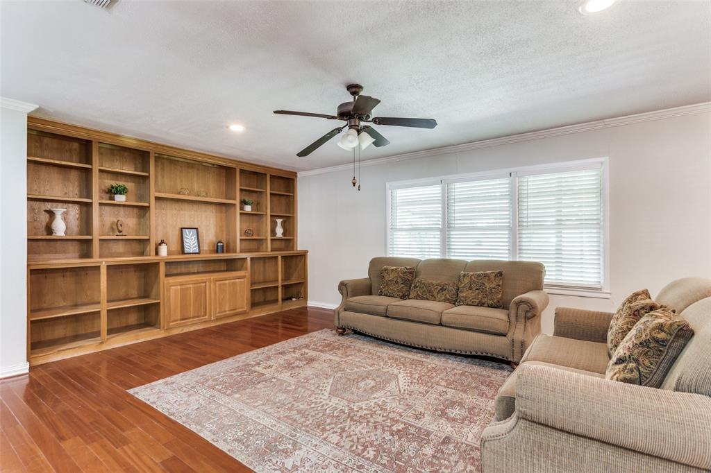 227 North 9th Street Jacksboro, TX 76458 - Photo 1 of 14 a living room with a couch and a book shelf
