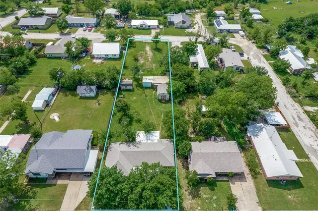 an aerial view of residential houses with outdoor space and street view