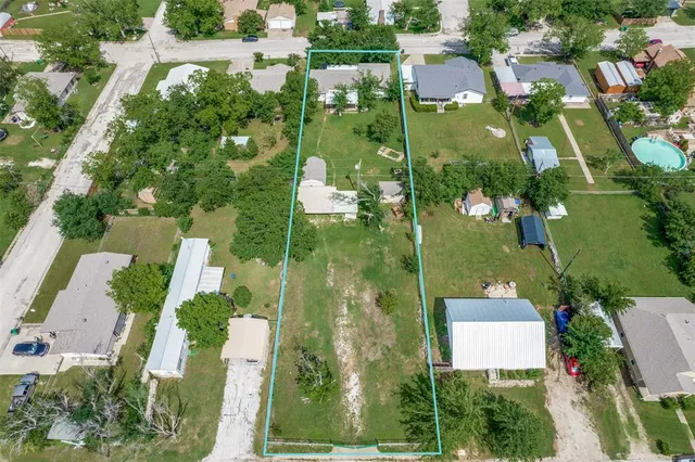 an aerial view of residential houses with outdoor space and street view